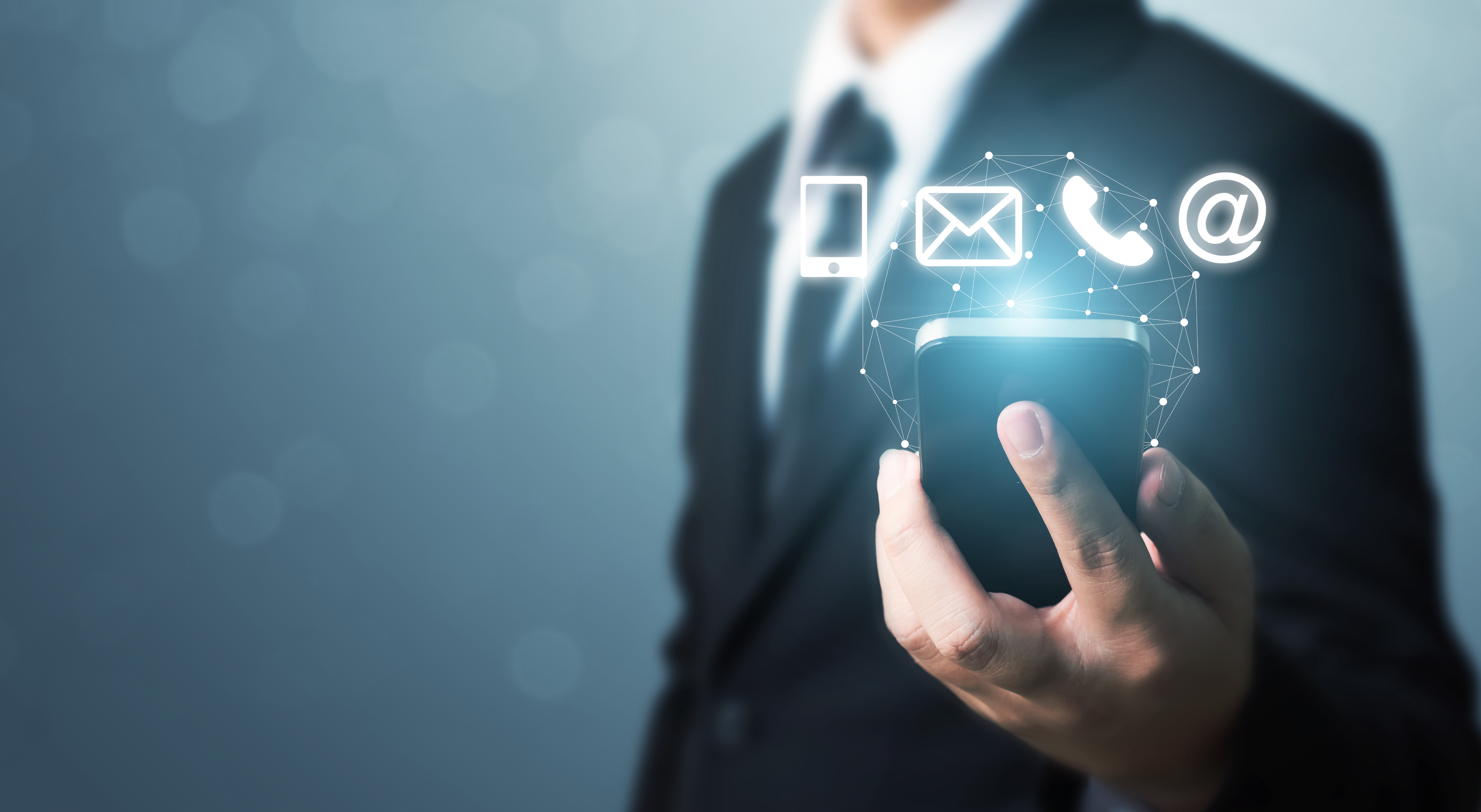 Businessman hand holding smart phone with icon mobile phone, mail, telephone and address. Customer service call center contact us concept